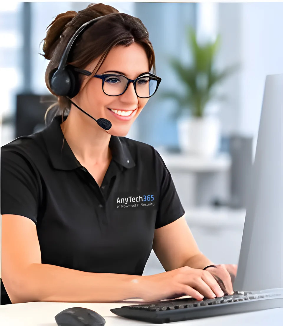 AnyTech365 technician with a headset working at a desk